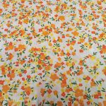 Sárga-narancssárga virágos pamutvászon